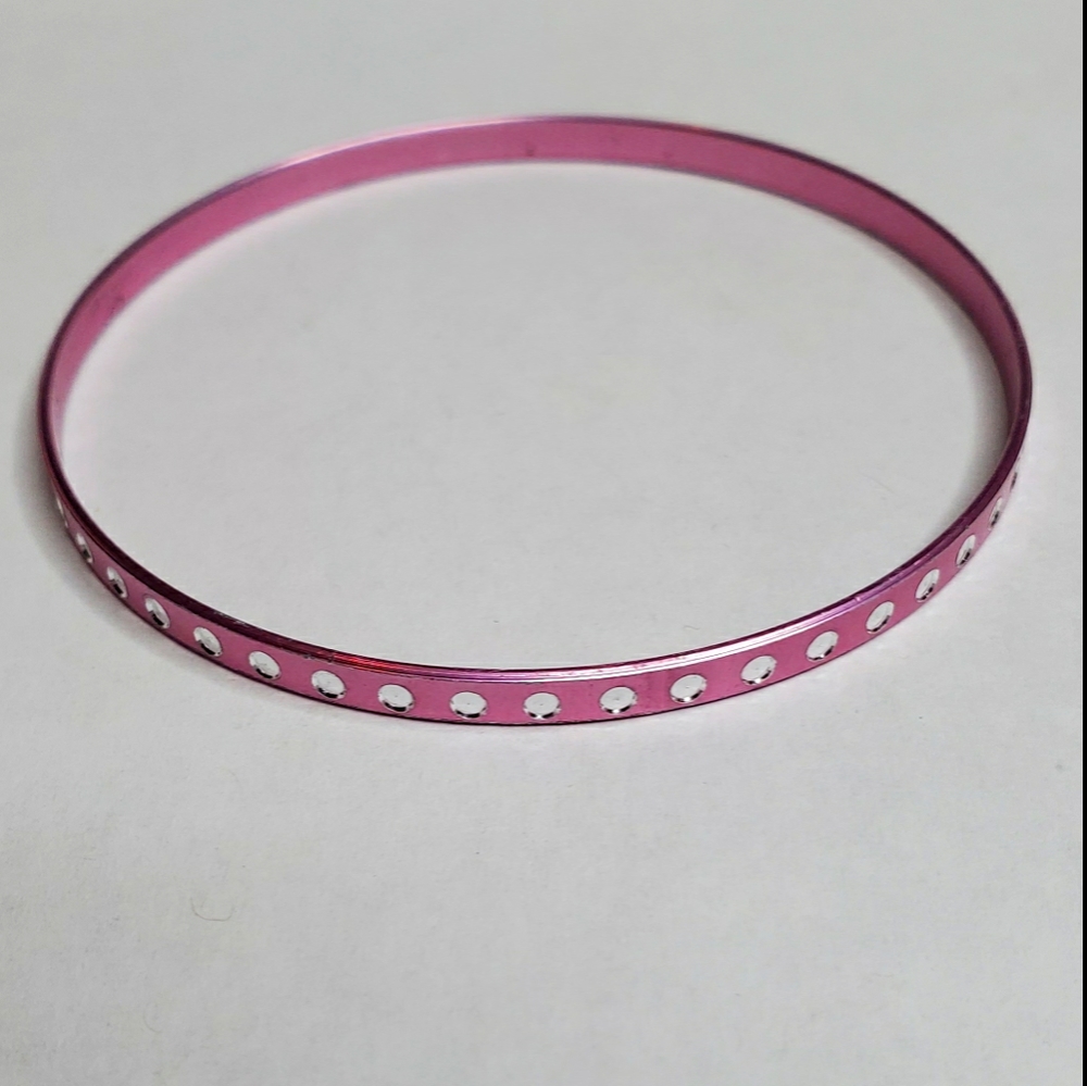 Pink bangle bracelet with white dots around